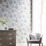 Contemporary  lounge / living room with chair and chest of drawers in front of large window